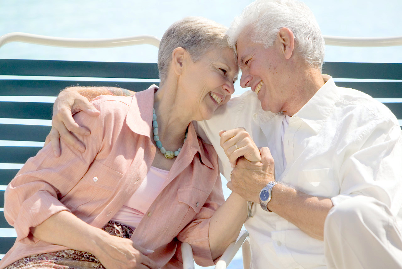 Senior Couple Relaxing in Deck Chairs