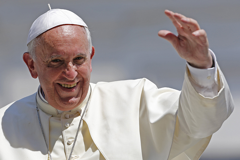 Pope Francis waves after leading his weekly general audience at St. Peter's Square at the Vatican