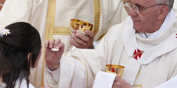 Pope gives first Communion to girl during Mass at Sts. Elizabeth and Zechariah Parish on outskirts of Rome