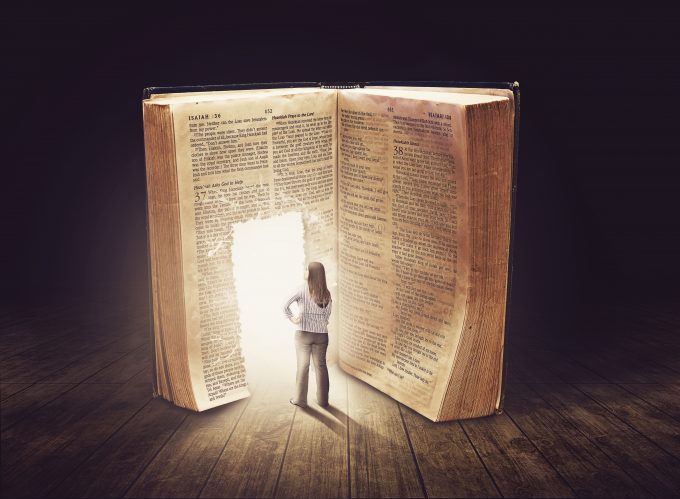 Woman looking at large book