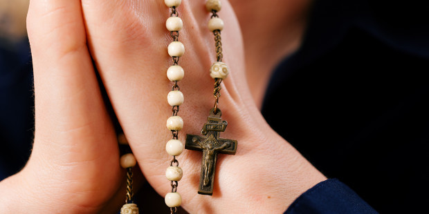 web3-woman-hands-praying-rosary-shutterstock