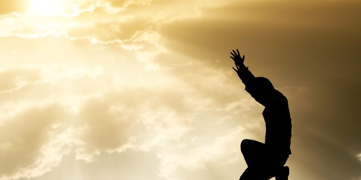 praying man on beautiful sky background