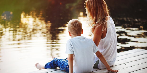 web3-family-sitting-near-water-and-watching-the-lake-at-sunset-shutterstock_6962680841