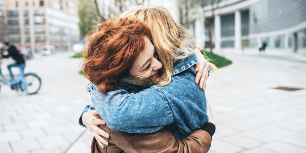 web3-woman-hugging-friends-city-shutterstock_422353582