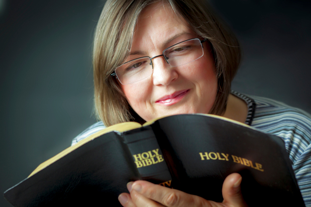 Adult Woman Reading a Bible. Close; Bible; reading; christian;