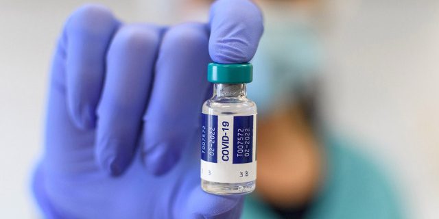 Cropped,Selective,Focus,Image,Of,Hand,In,Glove,Holding,Vaccine