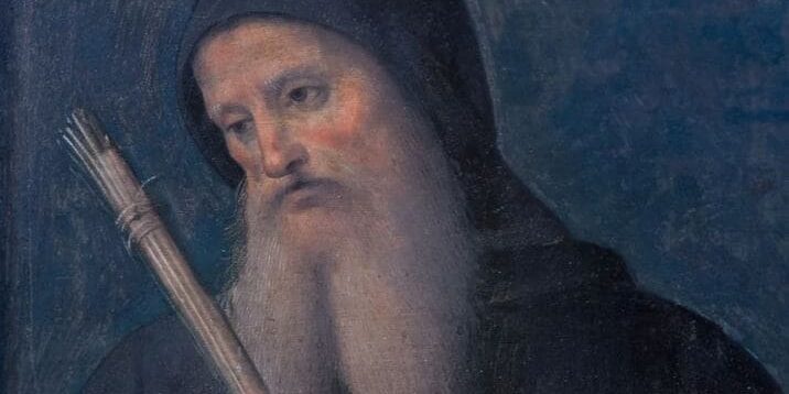 sao-bento (1) Ilustração de São Bento de barba longa e branca; ele usa um capuz preto sobre a cabeça.